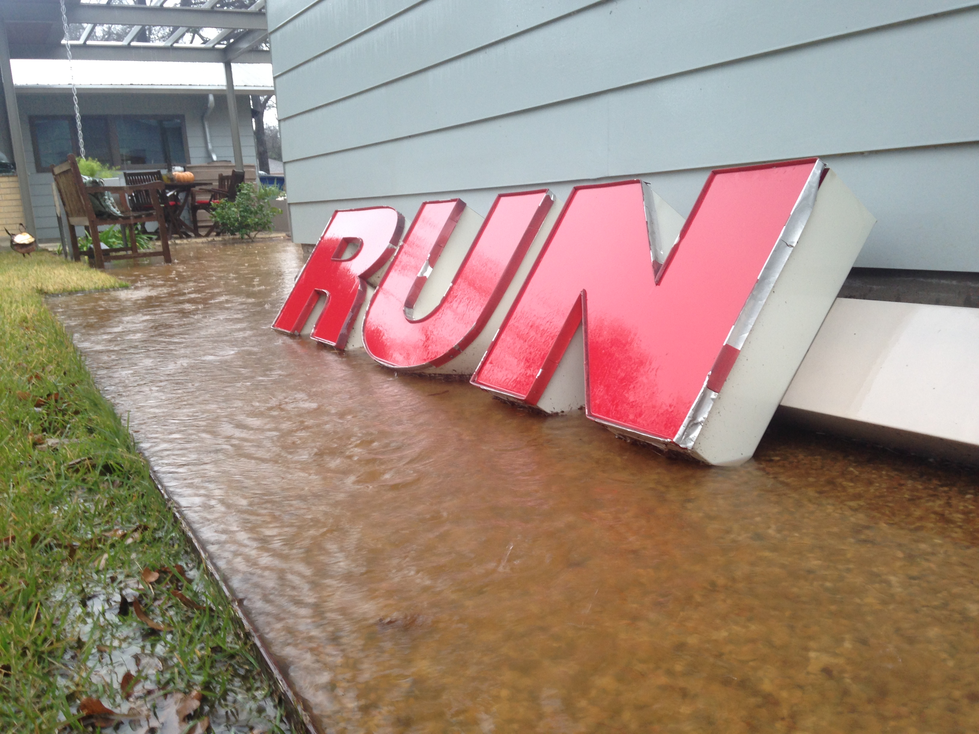 Red letters in a puddle spell out "run."