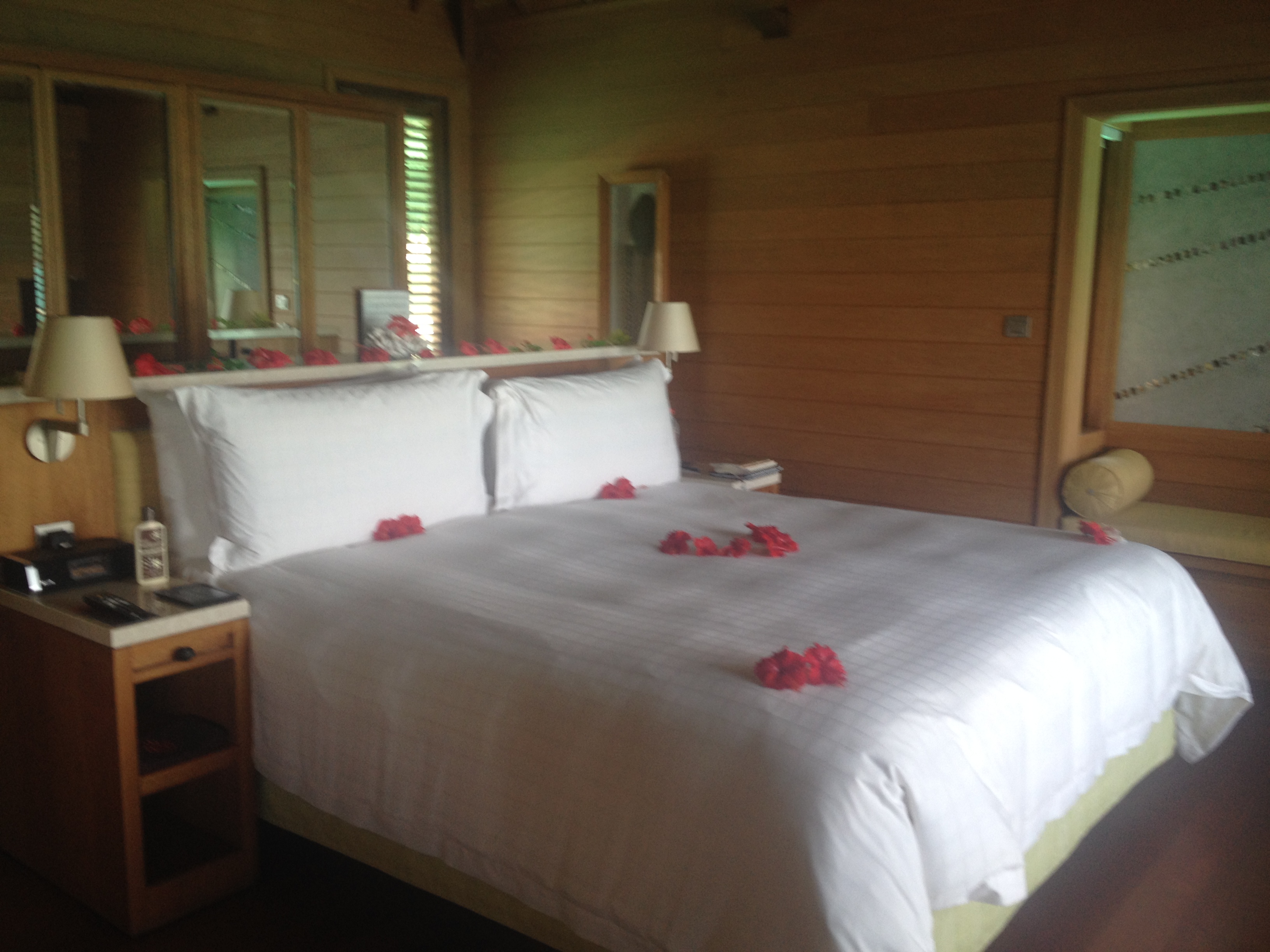 Bed at resort with red flowers