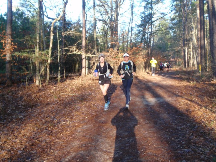 Two women running on a trail in Huntsville State Park