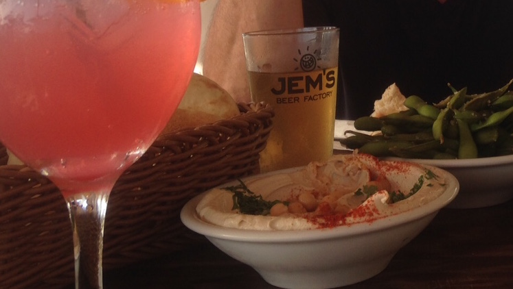 A dish of hummus in Tel Aviv, with cocktails.