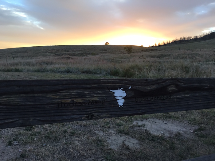 Sunrise over wooden slat at Hudson-Meng Bison Boneyard in Nebraska.