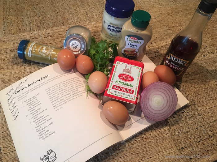 Cookbook with recipe for Curried Stuffed Eggs and necessary ingredients