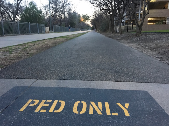 Pedestrian only pathway at Dallas' Katy Trail running next to concrete bike path