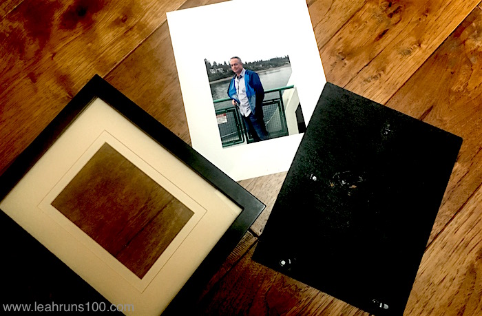 Disassembled picture frame with mat and photo for family Birthday Wall.